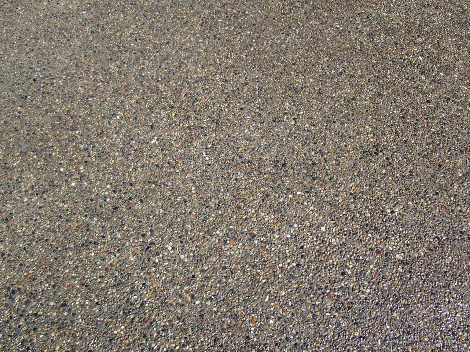 Close-up of exposed aggregate concrete driveway surface by Marcucci Concrete Construction in Oakland County, Michigan