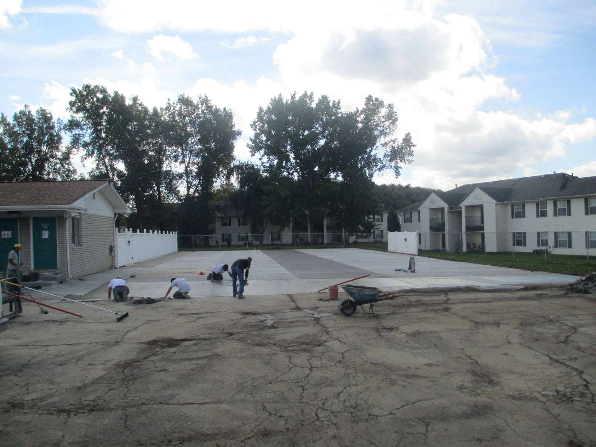 Marcucci Concrete Construction crew finishing new concrete parking lot panels at an apartment community in Oakland County, Michigan