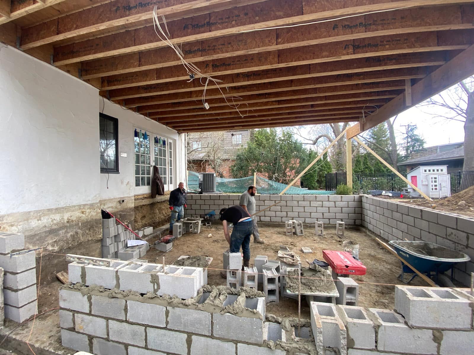 Crew building block foundation walls under a sunroom addition by Marcucci Concrete Construction in Oakland County, Michigan