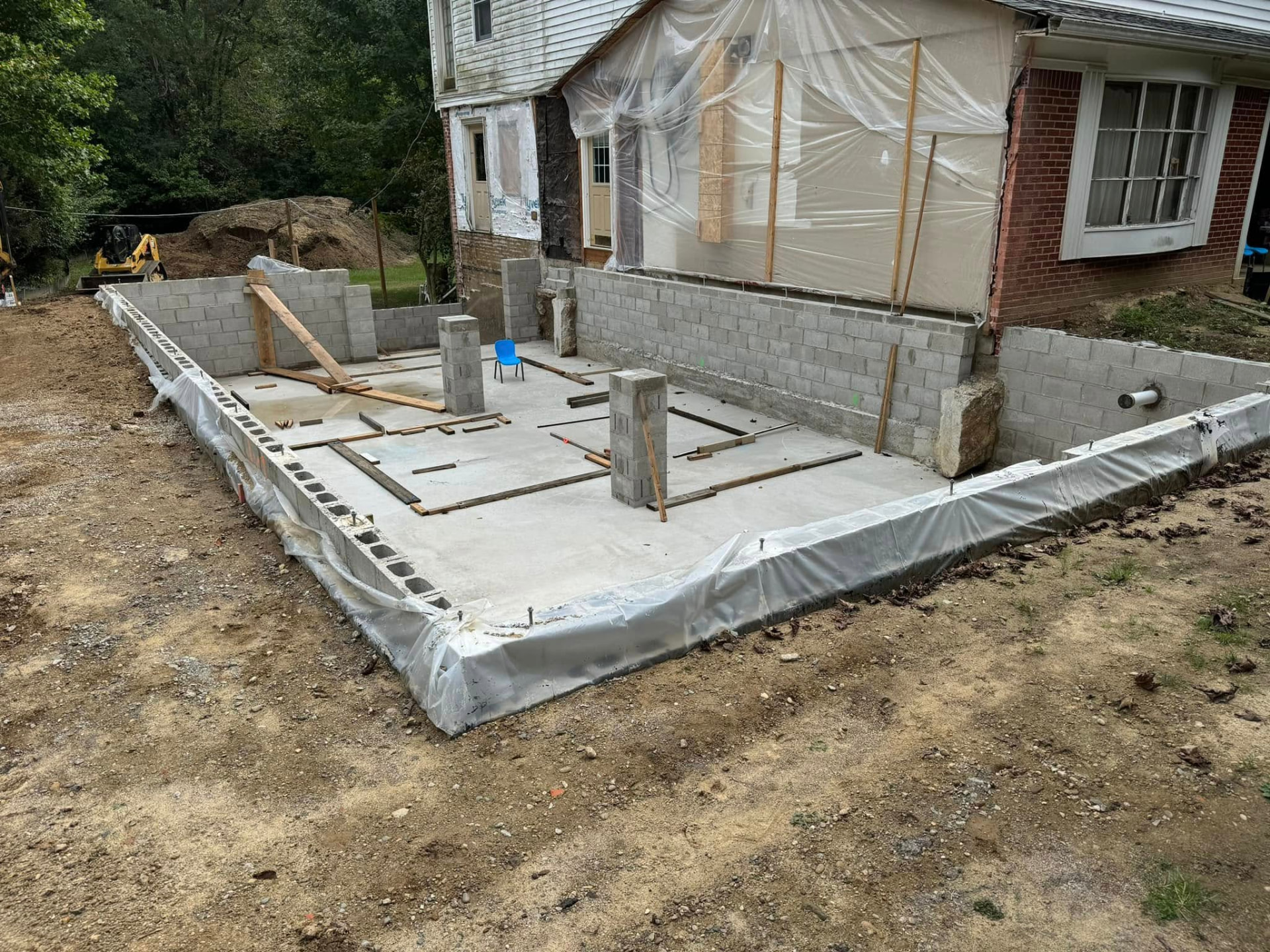 Residential addition foundation with concrete block perimeter walls and interior support piers. Marcucci Concrete Construction in Oakland County, Michigan.