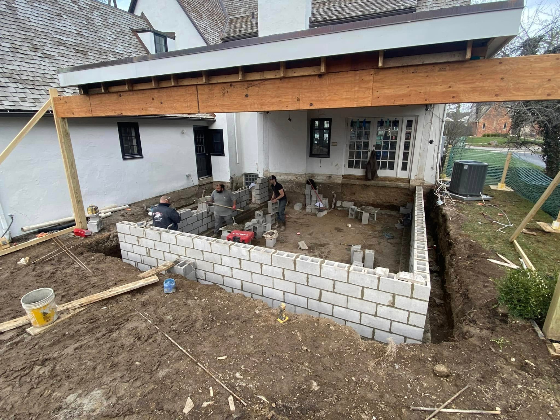 Marcucci crew laying block foundation walls for a sunroom addition in Oakland County, Michigan