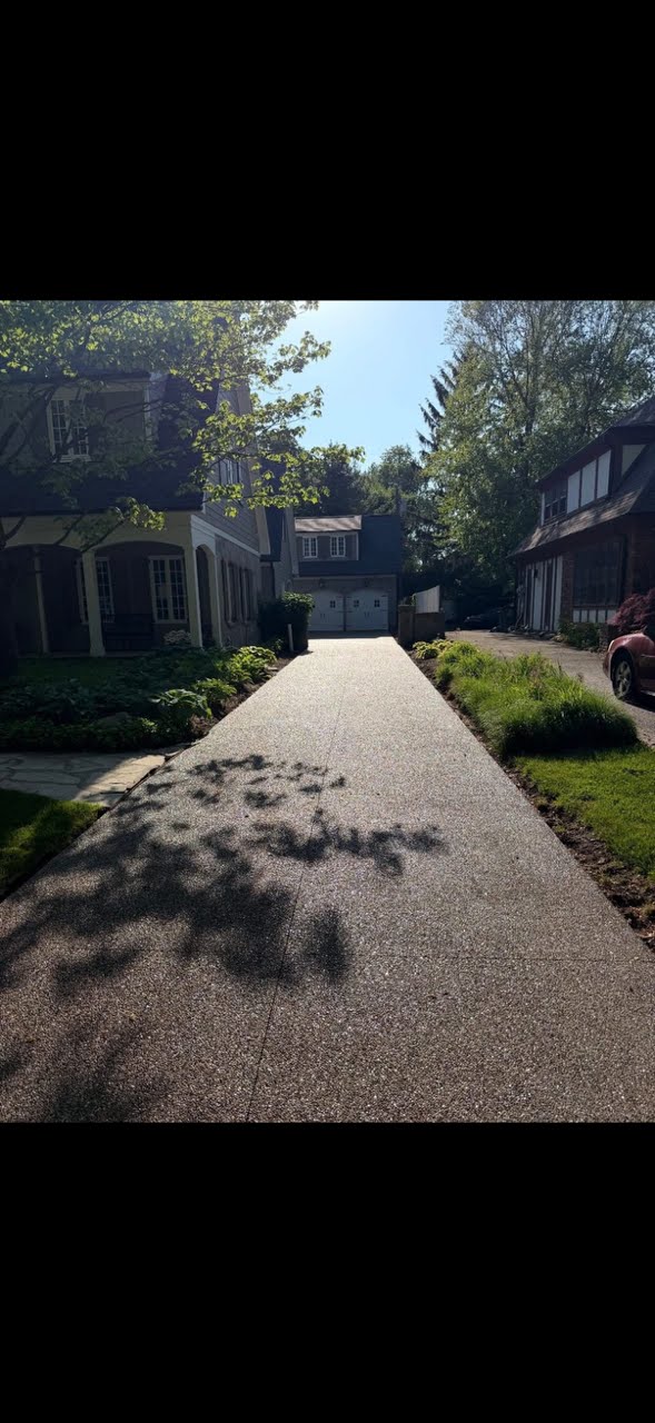 Long finished exposed aggregate concrete driveway by Marcucci Concrete in Oakland County, Michigan