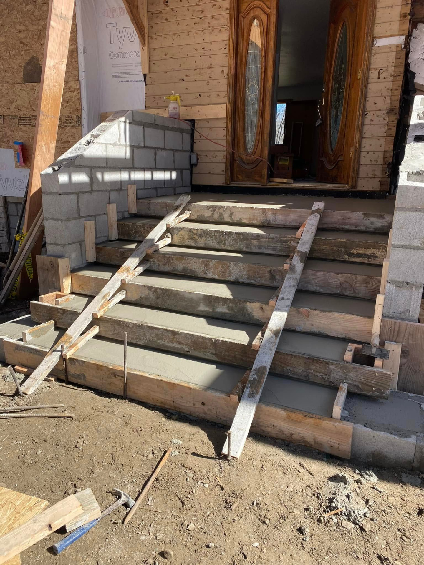 Freshly placed concrete front steps in formwork by Marcucci Concrete Construction in Oakland County, Michigan