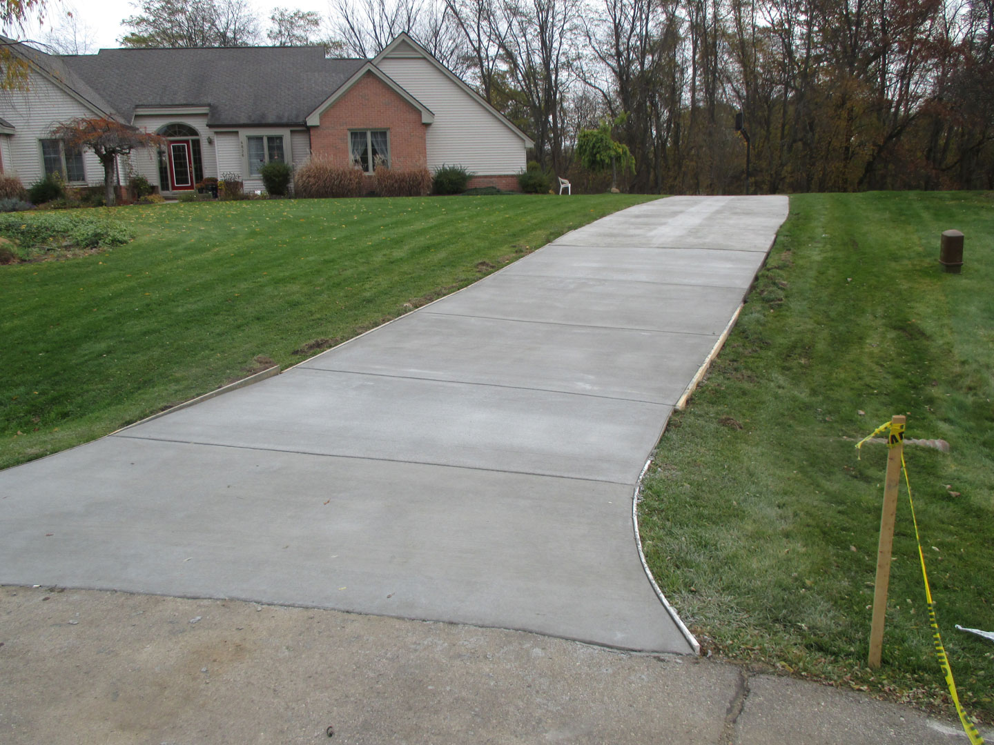 Suburban concrete driveway replacement with saw-cut control joints by Marcucci Concrete Construction in Oakland County, Michigan