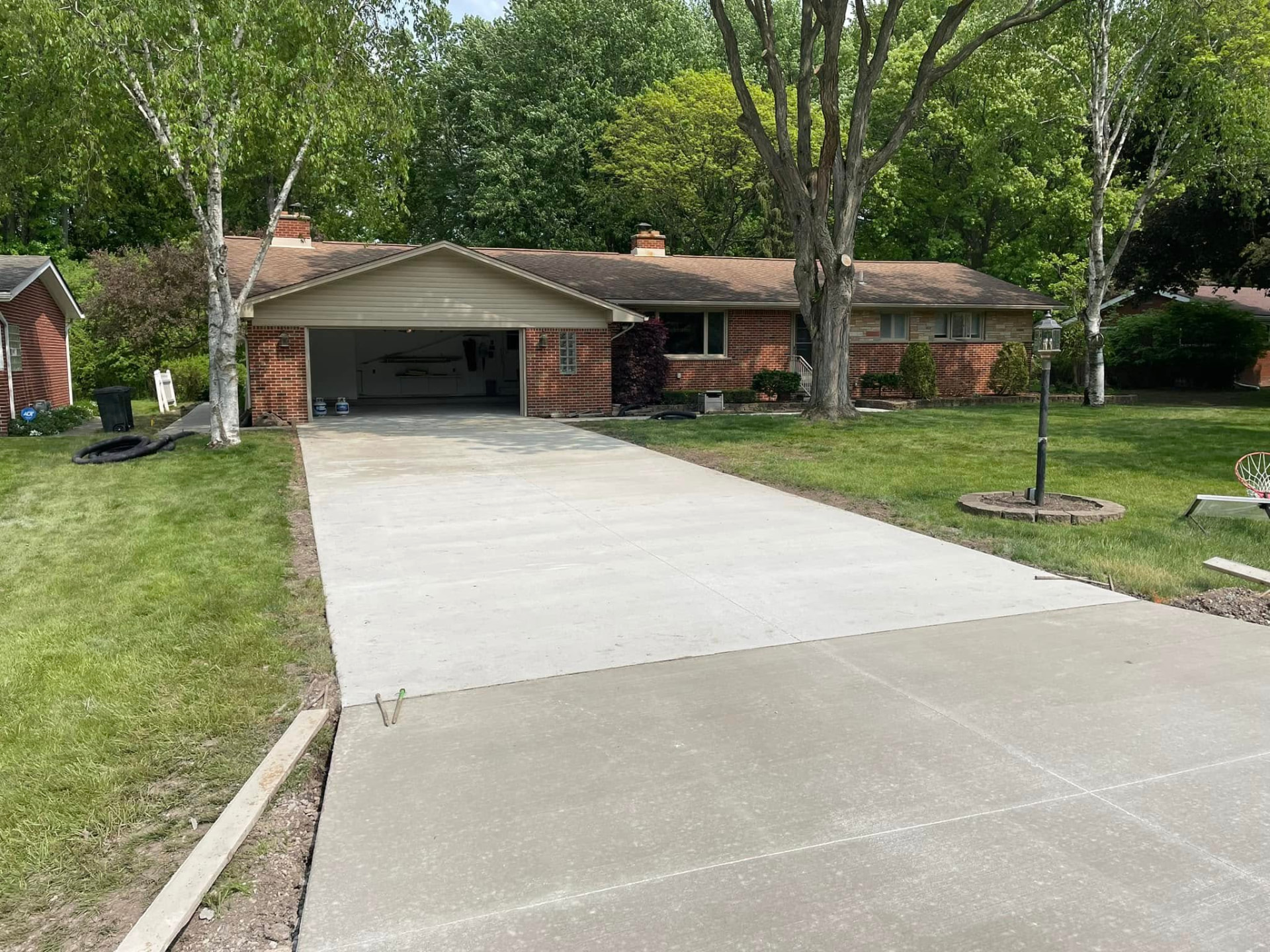 New broom-finish concrete driveway installed by Marcucci Concrete Construction in Walled Lake, Michigan