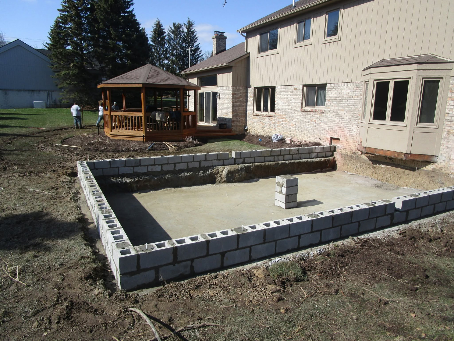 Concrete block perimeter walls and an interior support pier for a residential workshop addition. Marcucci Concrete Construction in Oakland County, Michigan.