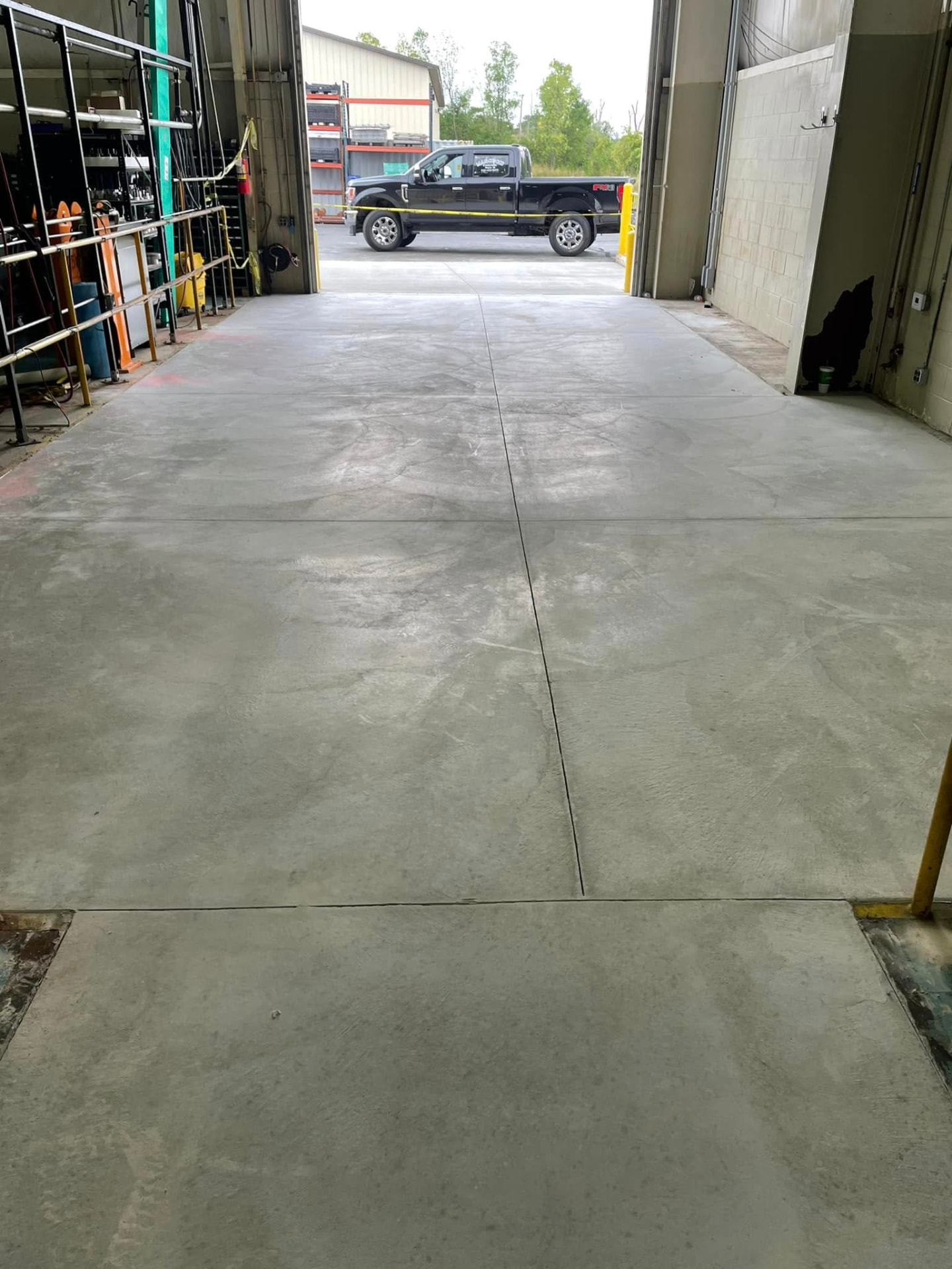 Finished commercial concrete floor replacement inside a mechanic shop by Marcucci Concrete Construction in Oakland County, Michigan
