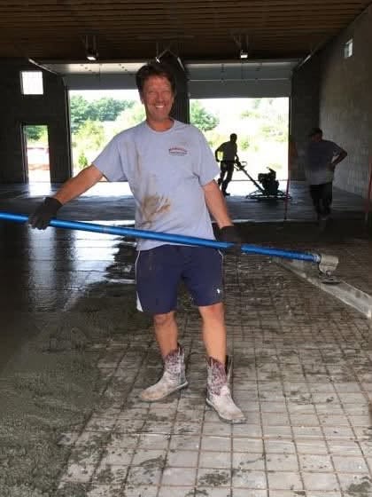 Tom Marcucci finishing a reinforced interior concrete slab during construction in Oakland County, Michigan