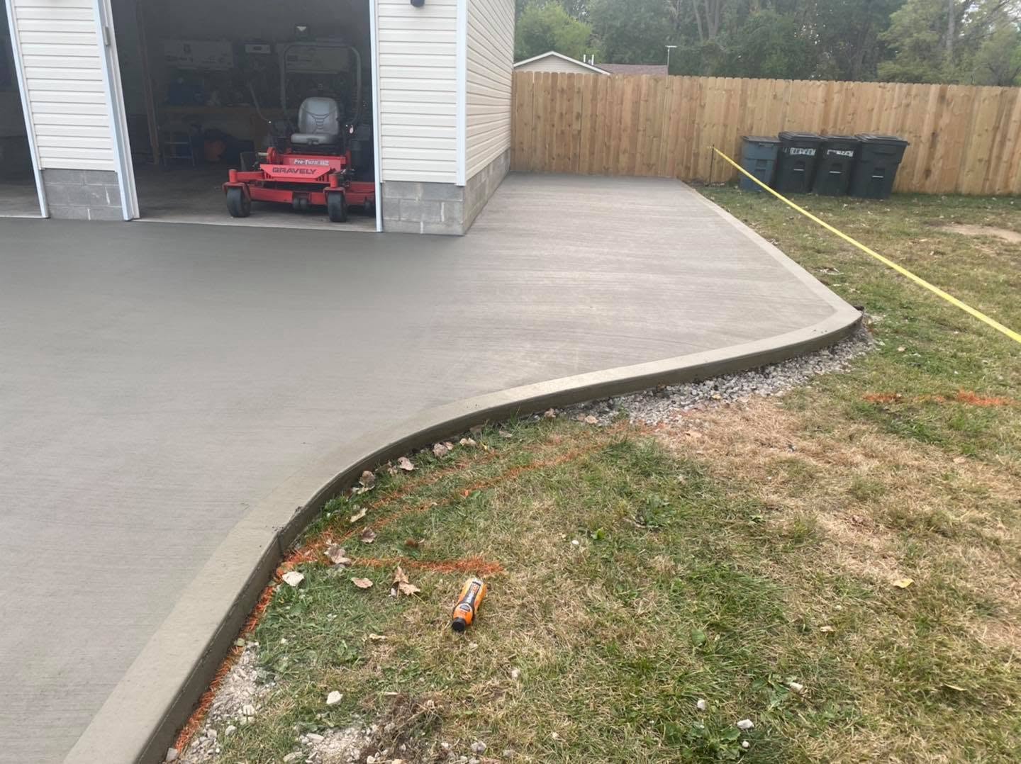 Concrete driveway expansion with curved curb edge by Marcucci Concrete Construction in Oakland County, Michigan