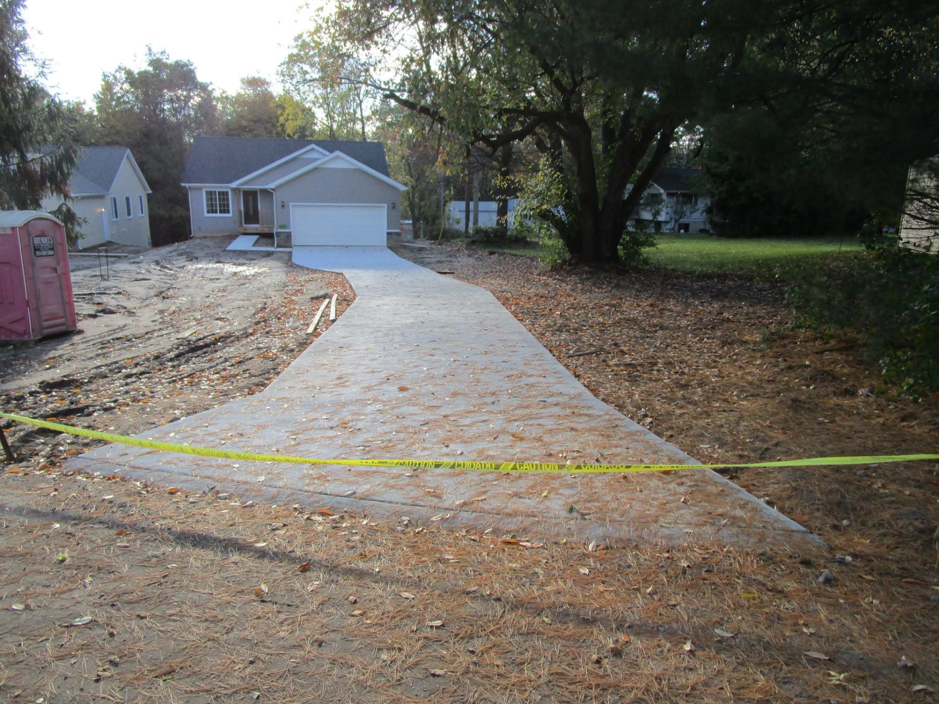 Long curving concrete driveway for a newly built home by Marcucci Concrete Construction in Oakland County, Michigan