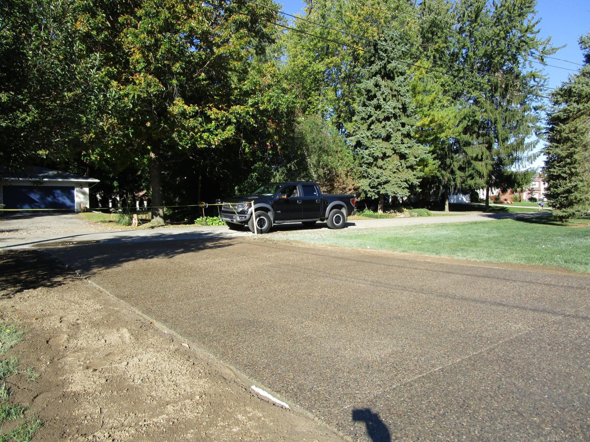 Exposed aggregate concrete driveway at a lake home by Marcucci Concrete in Oakland County, Michigan