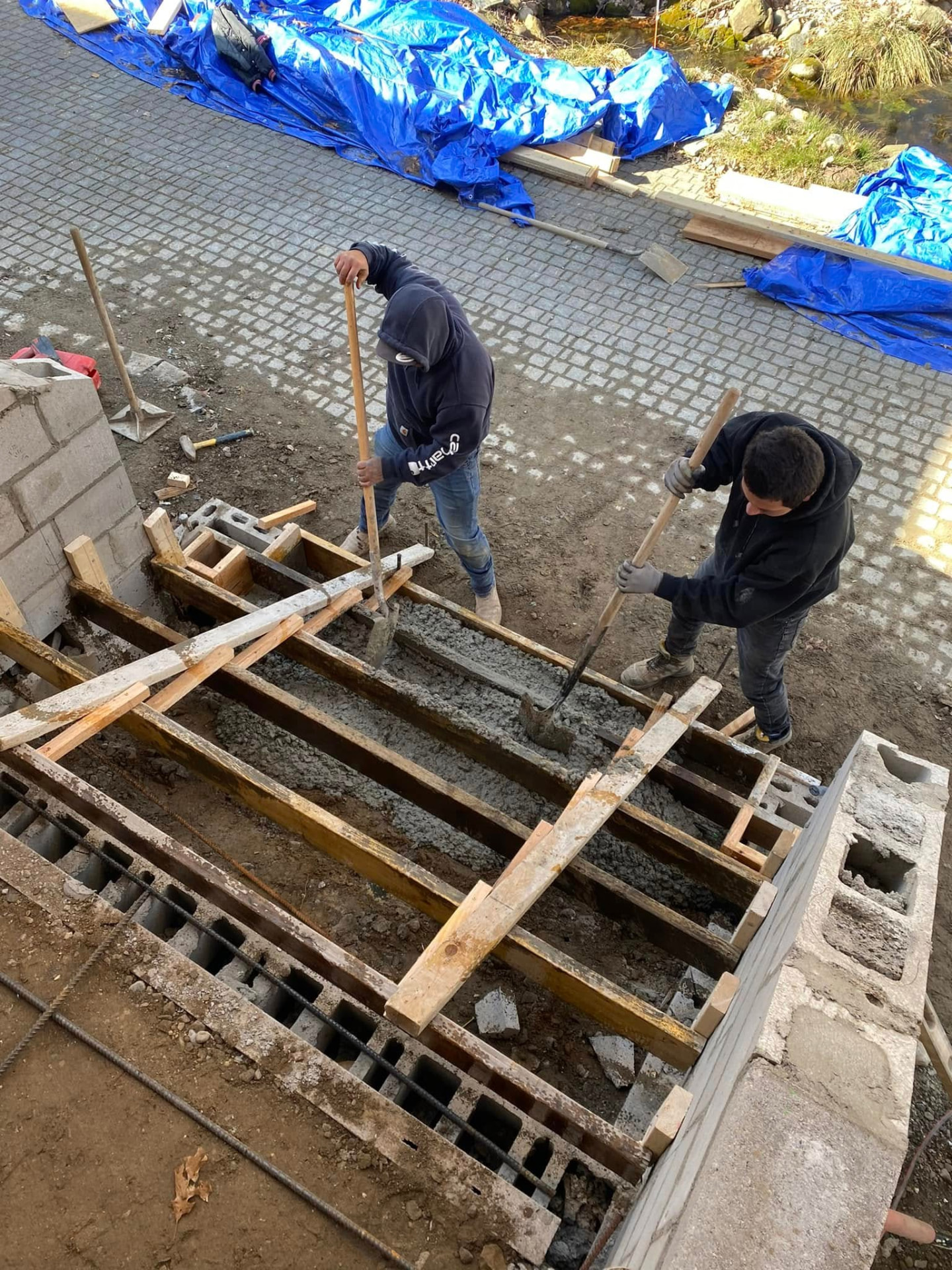 Marcucci Concrete Construction crew placing concrete front steps between masonry sidewalls in Oakland County, Michigan