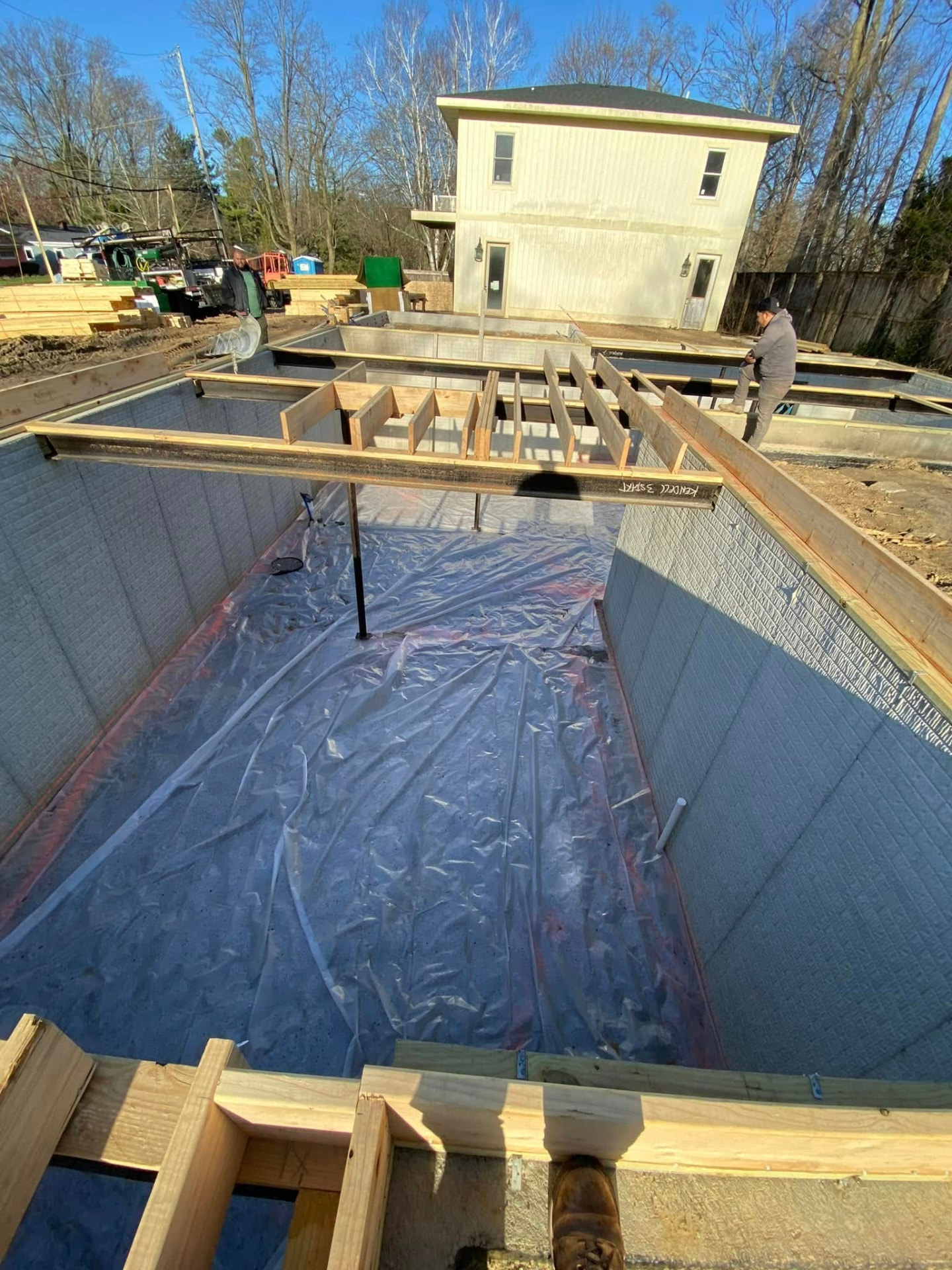Residential basement foundation walls with steel beams and prepared floor by Marcucci Concrete Construction in Oakland County, Michigan