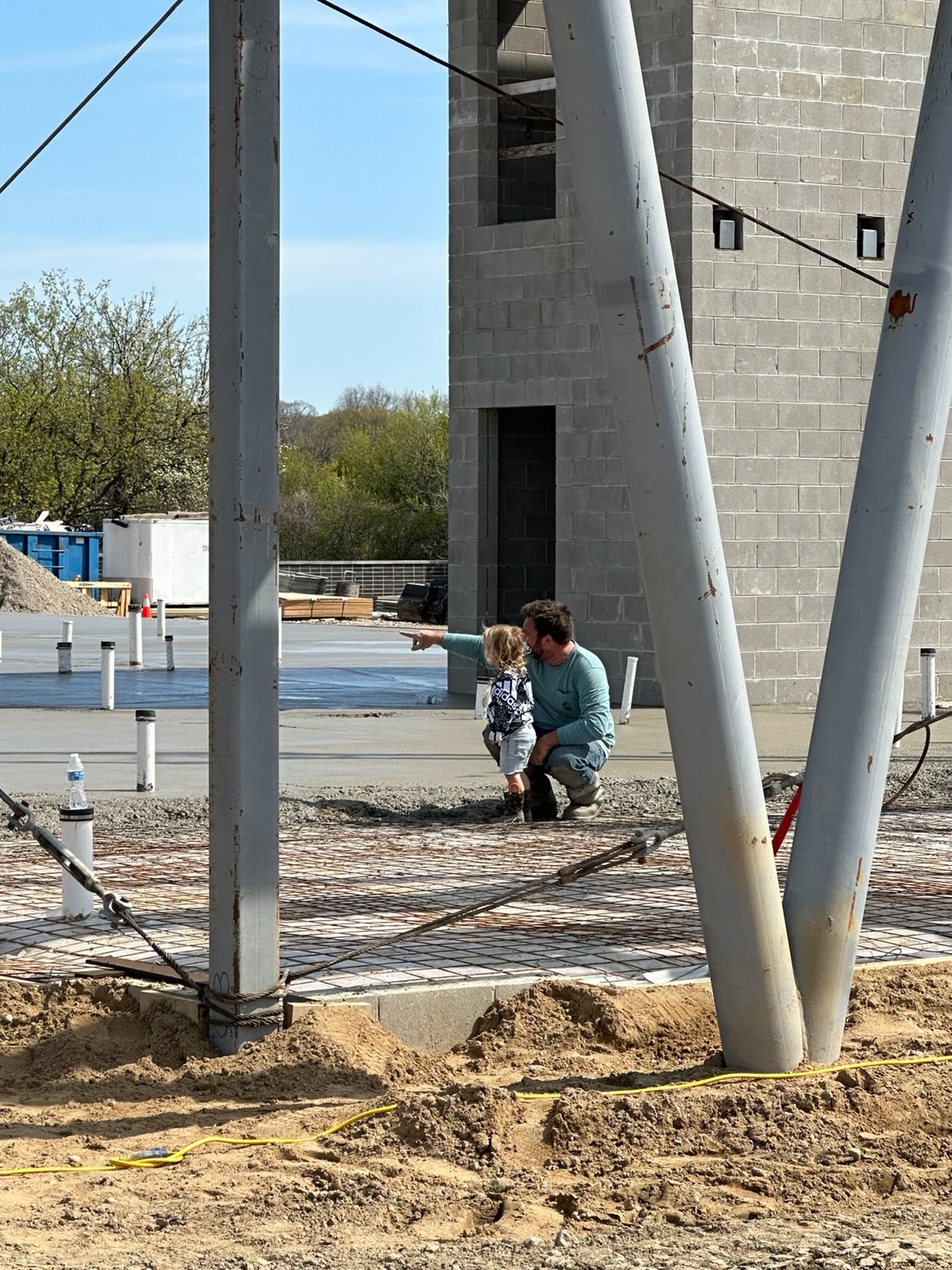 Marcucci family on a commercial concrete jobsite beside wire mesh slab reinforcement in Michigan