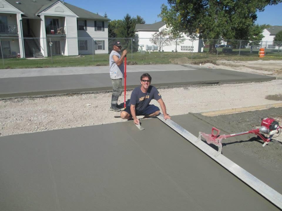 Marcucci Concrete Construction crew screeding a residential concrete driveway during placement