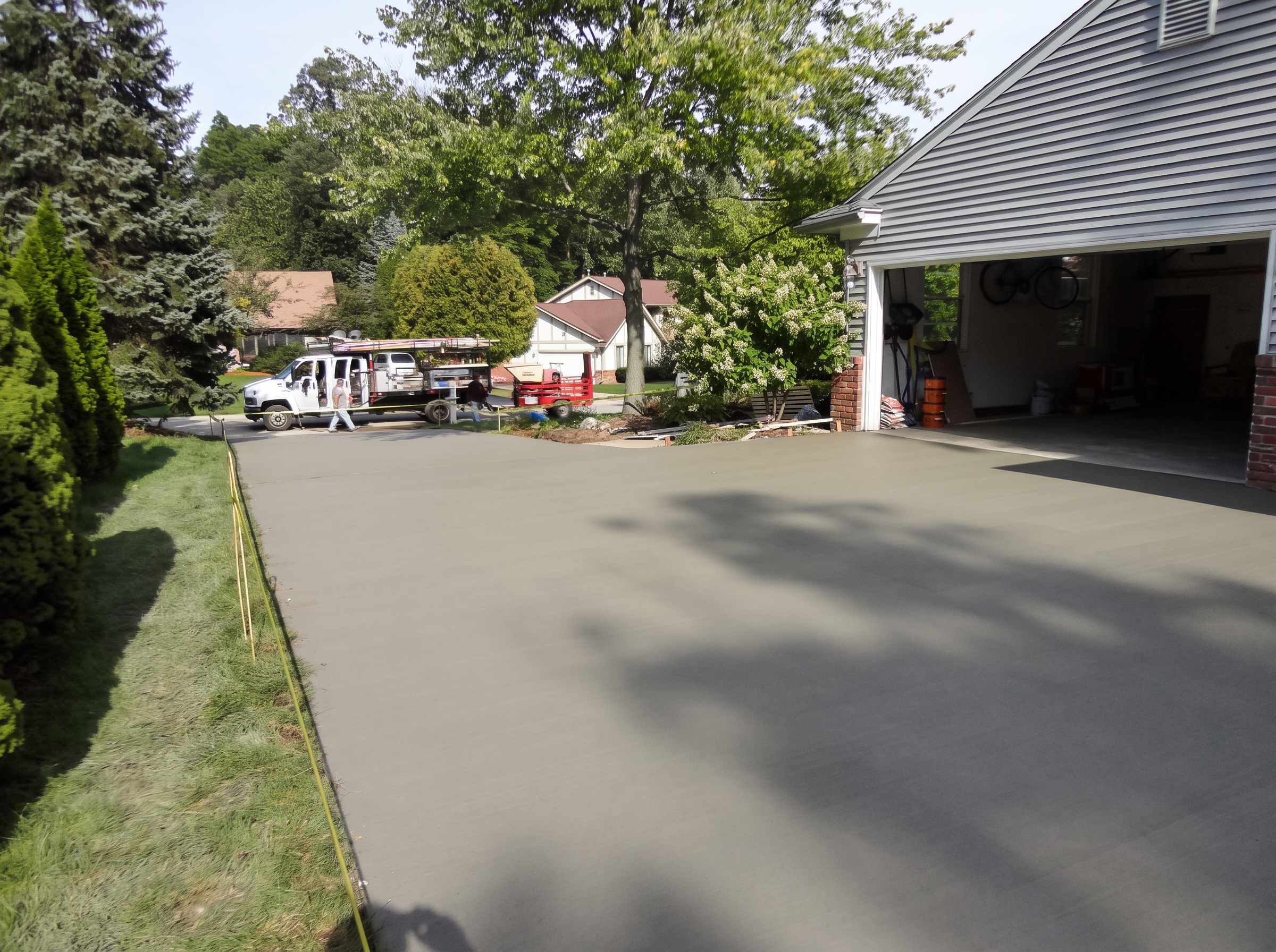Large freshly finished residential concrete driveway by Marcucci Concrete Construction in Oakland County, Michigan
