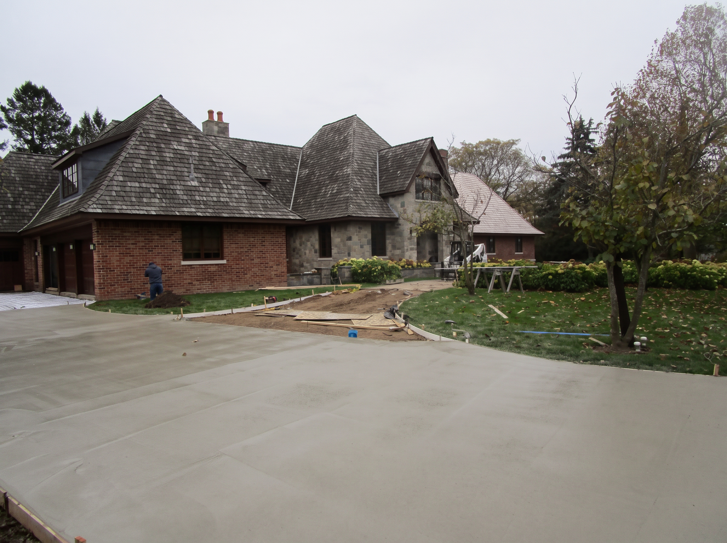 Large freshly placed concrete driveway at an estate home by Marcucci Concrete Construction in Oakland County, Michigan