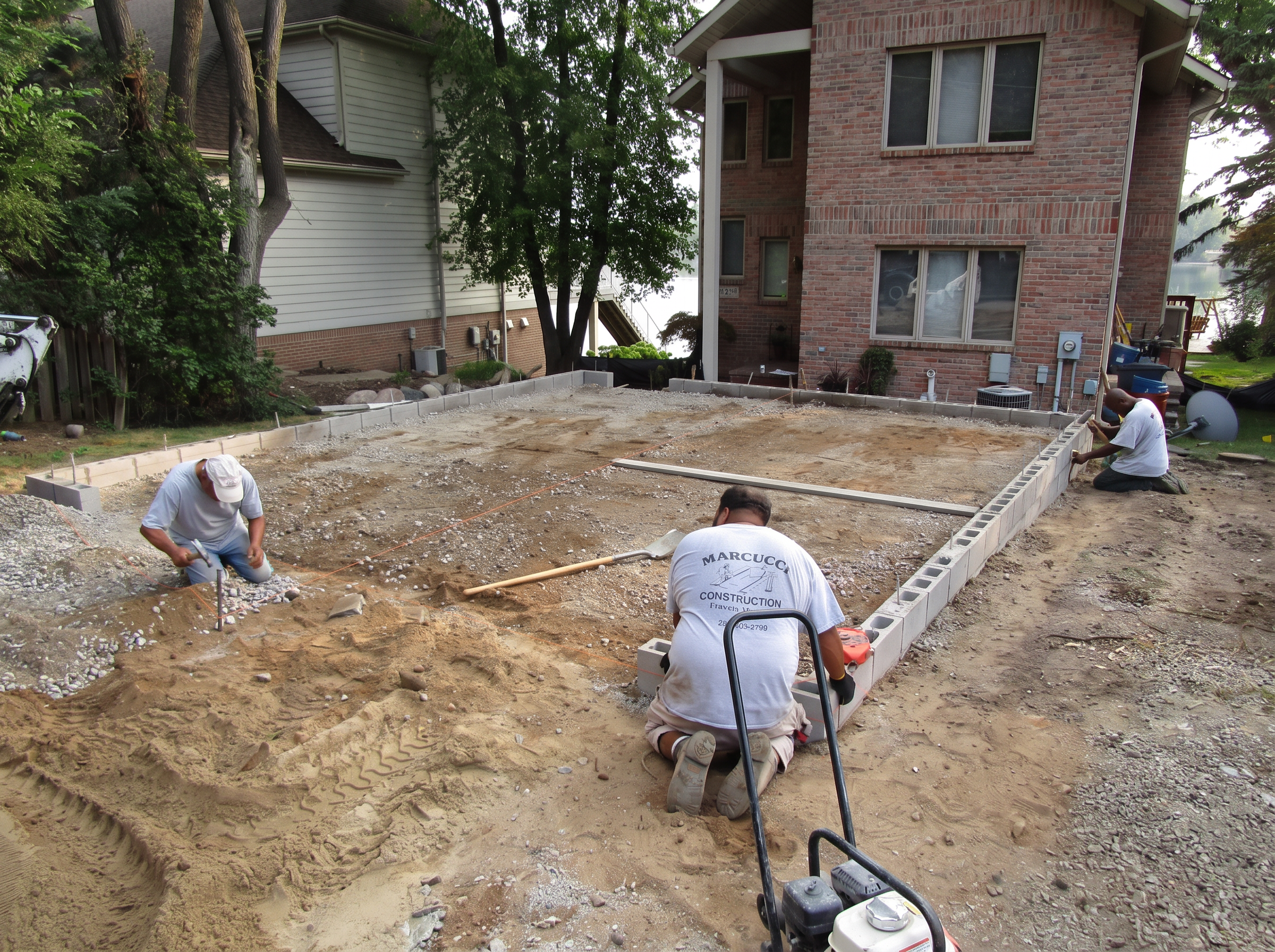 Marcucci Concrete Construction crew laying block foundation for a lakefront home addition in Oakland County, Michigan